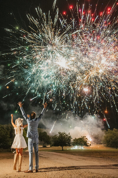 wedding couple kiss watching fireworks after reception