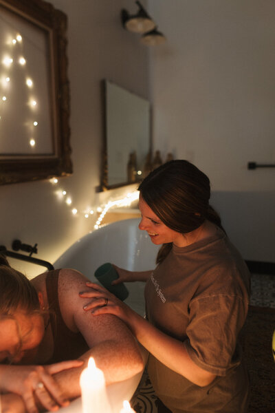 Savannah providing hands-on doula support during a peaceful home birth in Southern Utah.