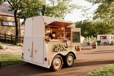 Horse trailer converted into a bar with the window open looking into the bar working area