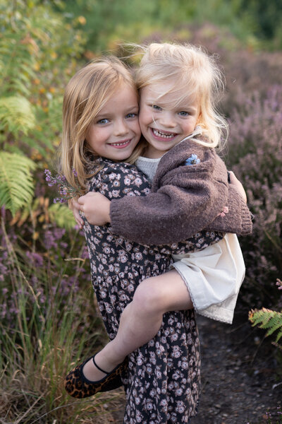 family outside sunset kids in blanket in field