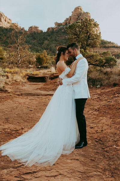 bride and groom standing together in sedona