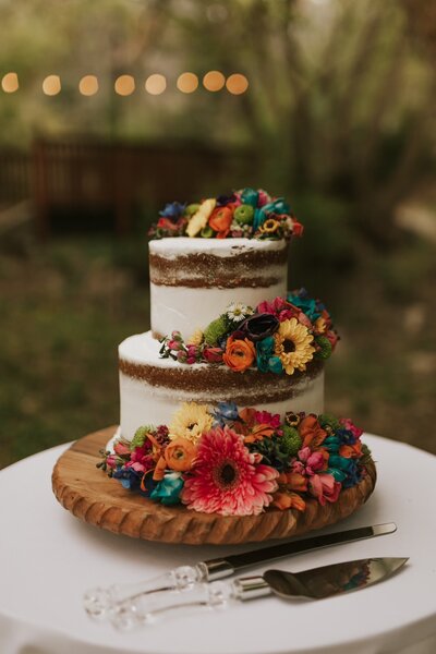 bright flowers arranged on wedding cake