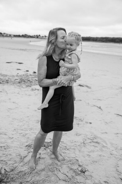 Adult and kid on the beach  with water in back | Taken by Maine Photographer