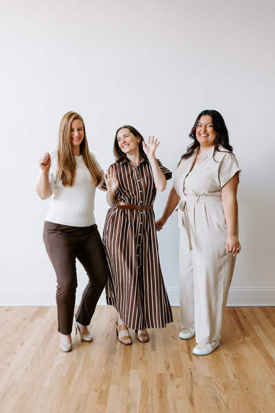 The Bridget Mary Weddings and Events team posing playfully, smiling and standing close together.