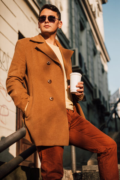 fashionable man wearing a brown coat