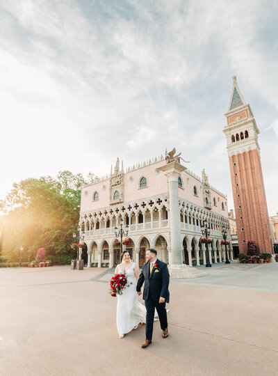 Bride and groom walking in Venice Italy pavilion at Epcot for their Disney's FairyTale Wedding