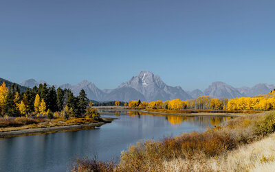 Wyoming mountain range with lake and fall colored trees