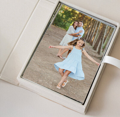 girl in light blue dress spinning with her parents watching from behind by york pa photographer