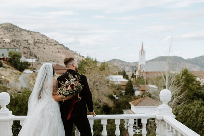 bride and groom on top of a building