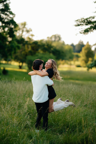photo taken by virginia elopement photographer of man holding a woman while spinning her around in a field