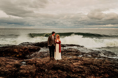 Couple with waves crashing on Lake Superior