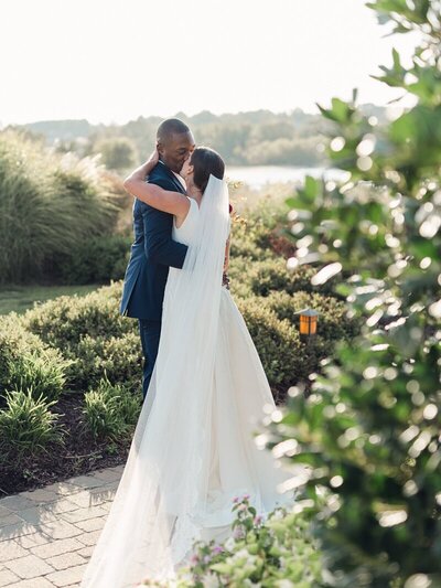 Bride kissing groom at wedding venue taken by one of the top baltimore wedding photographers Nicole Simensky