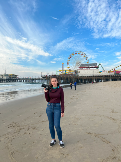 Woman with a camera on santa monica beach