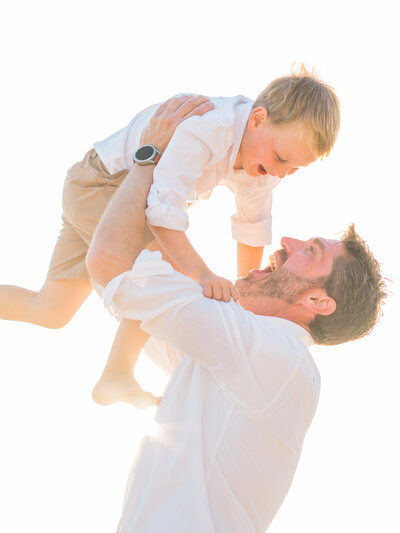 Family Photographer,  mother kneeling down and resting her forehead against her young daughter's forehead