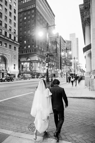 Bride and groom black and white portrait walking in the city