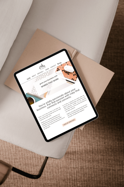 Screenshot of Erika Fitzgerald’s first freelance copywriter website displayed on an iPad, marking the start of her online business journey