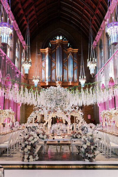 Lush florals hang from the ceiling and decorate a wedding reception at Trinity Cathedral in Cleveland