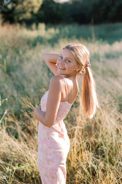 Malibu senior photographer – natural light golden field portrait of high school senior girl preparing for senior photos