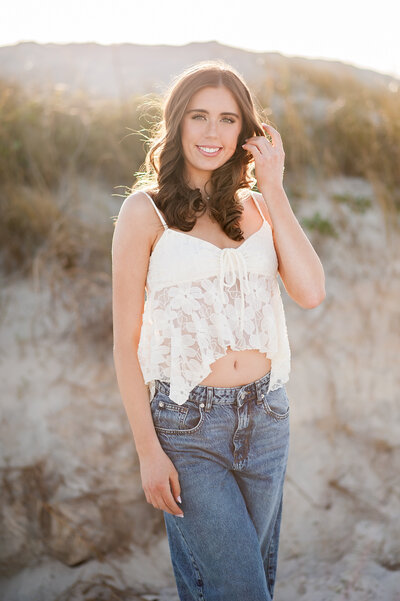 high school senior girl with short blonde hair standing in front of pink stairs and building in winter park, shot by Melissa Vinsik Photography - Orlando Senior Photographer