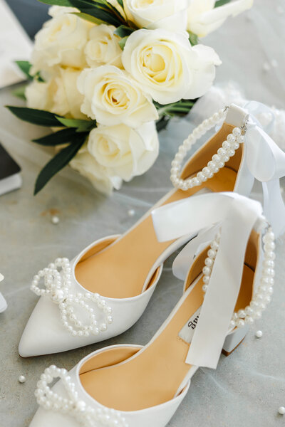 A pair of wedding shoes with adorable pearl details.