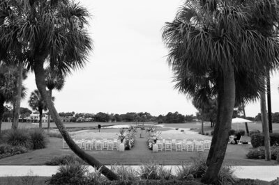 ceremony details in between two symmetrical palm trees on golf course for wedding in Jupiter, FL - by Daniella Diaz Wedding Photographer