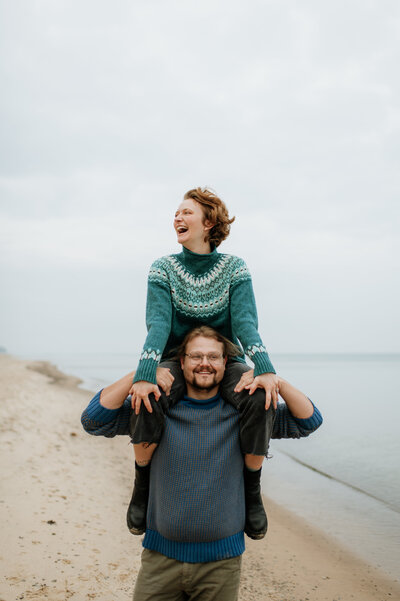 Couple piggyback photo beach engagement session