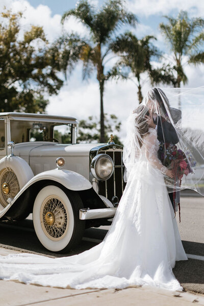 bridal portraits during cocktail hour in front of a luxury rolls royce in chula vista