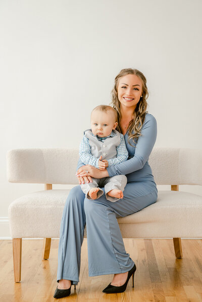 Mother in blue pantsuit holding her baby son during their studio portraits by Chicago Family Photographer Kristen Hazelton