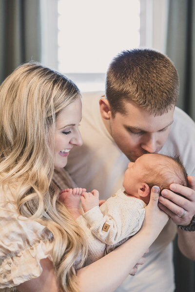 mom and dad hold baby for new born portraits in las vegas nevada