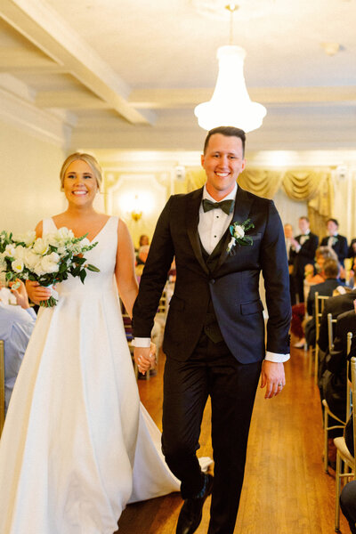 Bride and groom smiling as they walk down the aisle after their wedding at Loose Mansion, captured in authentic, emotional documentary style for couples who value presence over perfection