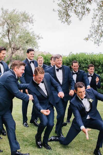 Groomsmen in navy suits and bowties