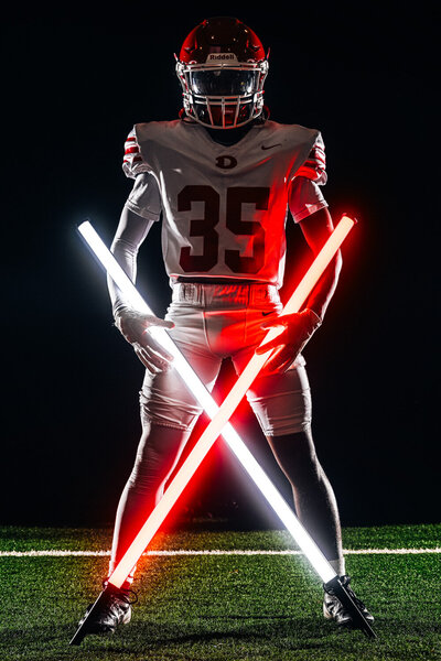 a football player poses during a photo shoot in dalton georgia