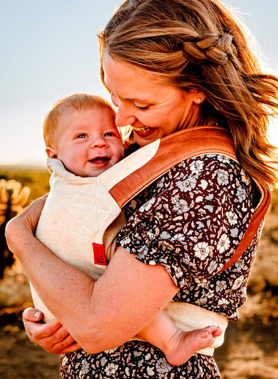 arizona mom baby wearing and hugging her son in a desert location for photography session