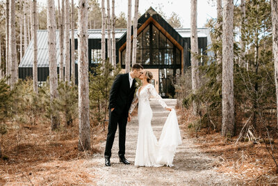 bride and groom  kissing among the pines