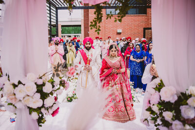 A sikh bride and groom during their anand karaj wedding ceremony at the marriott owing mills in maryland