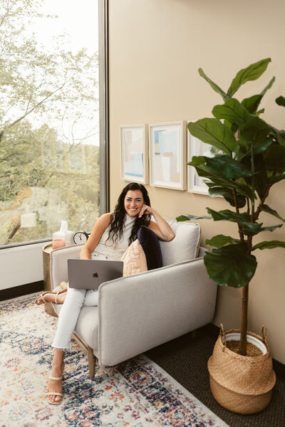Lizzy sitting in the Lux Counseling office