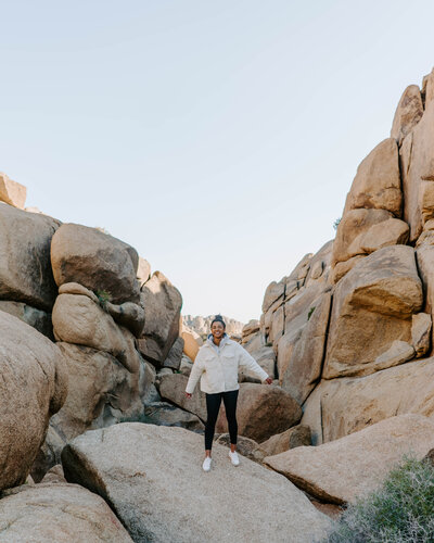 woman stands among rock formations