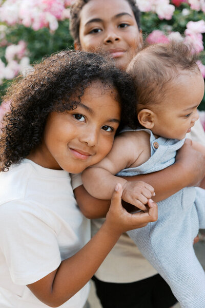Image of boy holding his baby brother's hand taken by Sacramento Newborn Photographer Kelsey Krall Photography