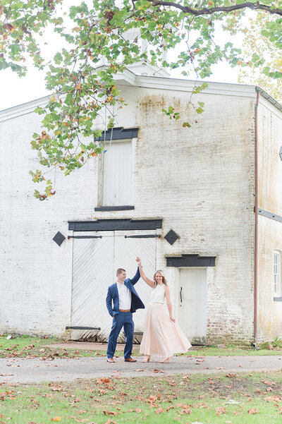 Allaire Village fall engagement session bridde and groom twirl