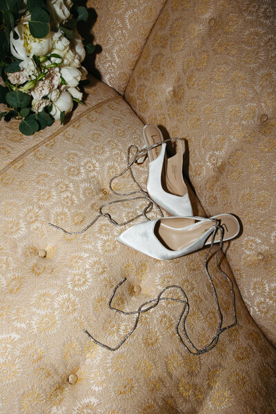 Diamond ring wedding rings sitting on marble counter with blue hydrangeas