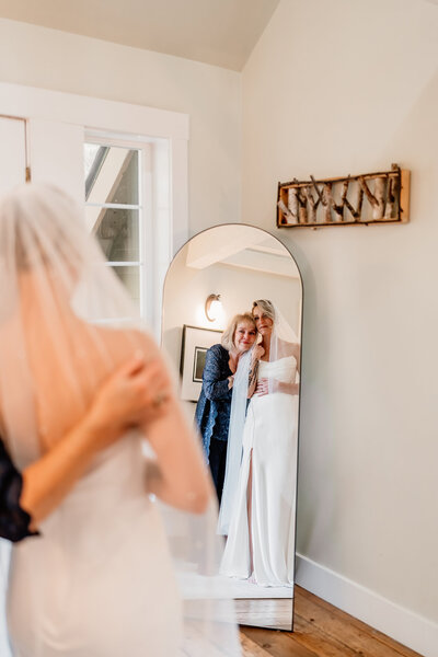 a mother and daughter sharing a quiet moment before the ceremony, candid photography by aim true photography