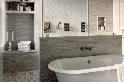 A primary bathroom renovation in a Boston brownstone with light grey Waterworks tile and a freestanding tub by top interior designer companies in Boston.