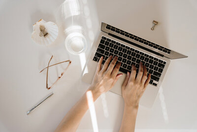 keyboard and journal on a white desk