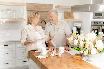 Southern California Wedding  floral studio founder couple studying wedding samples in a beautiful kitchen counter