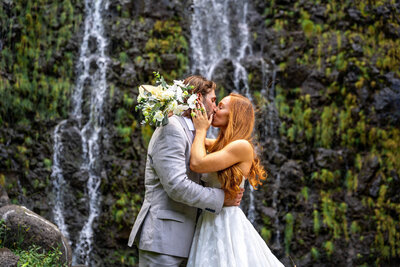 Wedding photos in front of waterfall, taken by Big Island photographer - Hawaii Adventure portraits