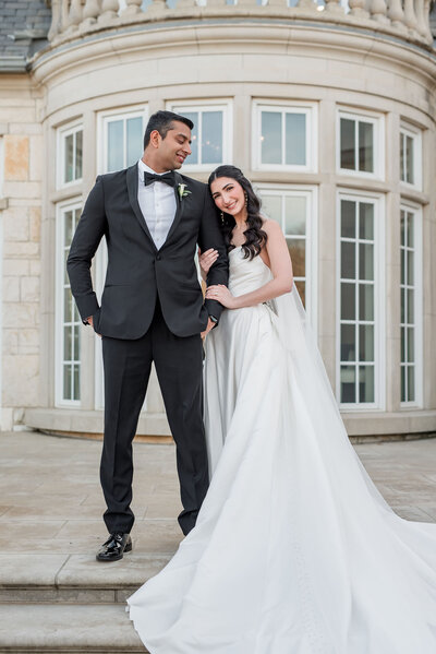 Portrait of bride in a trumpet gown with tulle and wedding bouquet