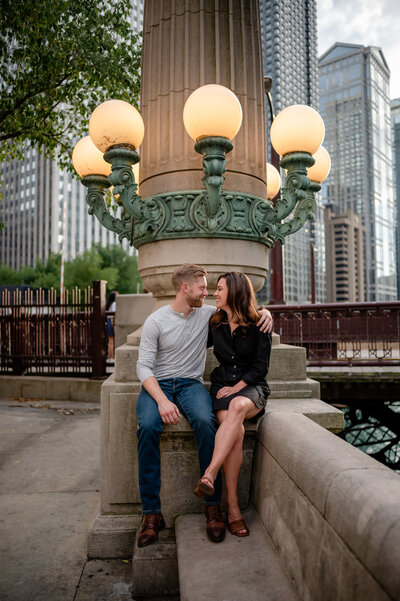 An engaged couple talk on the Chicago riverwalk