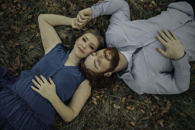 couple laying together in the grass