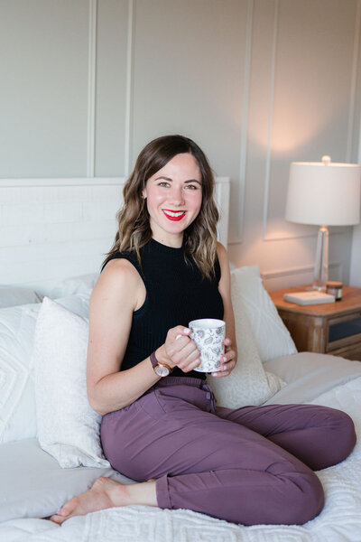 woman sitting on the bed smiling at the camera