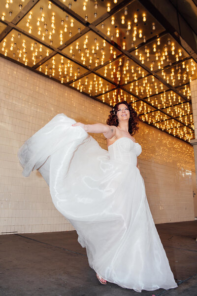 A bride swinging out one side of her dress.